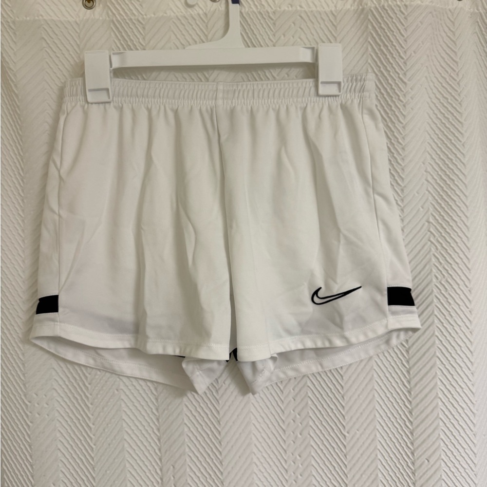 Nike Women's White Athletic Shorts with Black Swoosh and Side Tabs